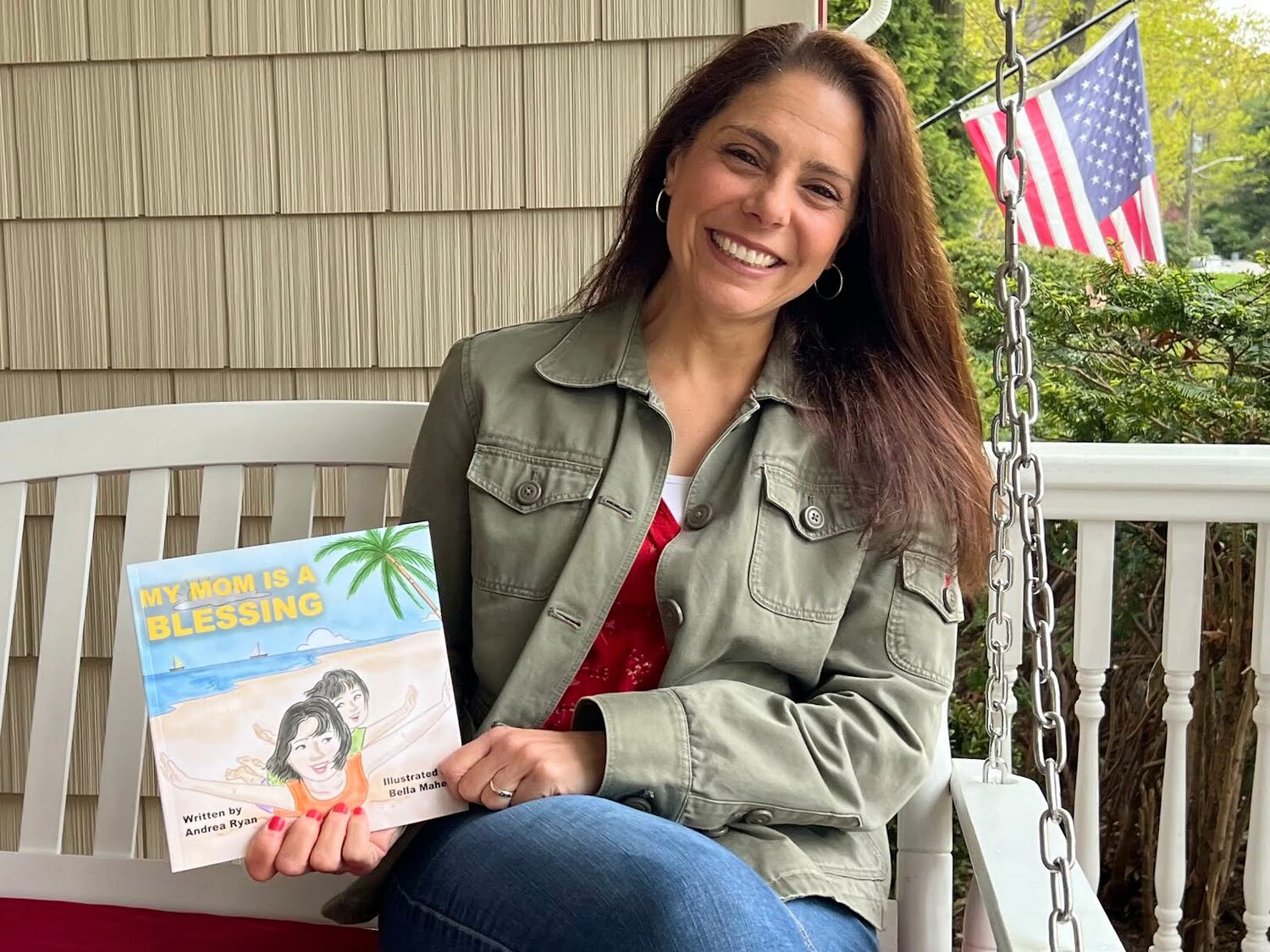 Author Andrea Ryan of the Lighthouse Mission in Bellport holds her freshly published children’s book, “My Mom is a Blessing.”